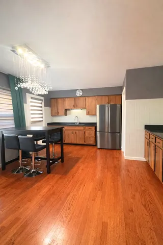 a view of a kitchen with furniture and wooden floor