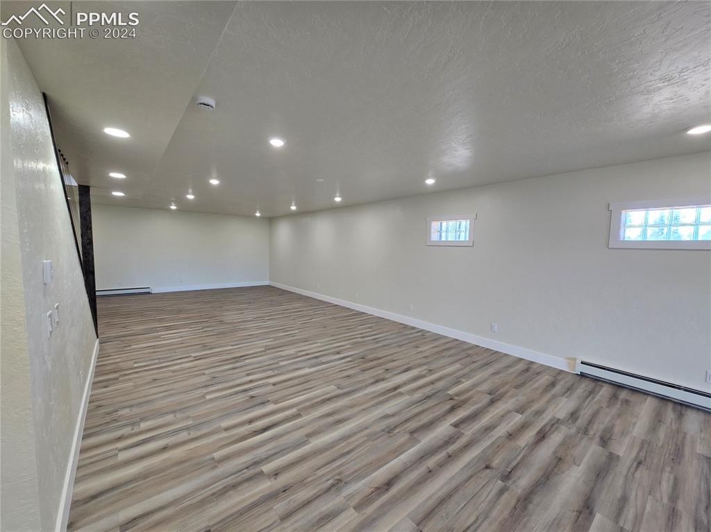 33036 Meadow Ridge Lane Trinidad, CO 81082 - Photo 39 of 50 Basement with a textured ceiling, light hardwood / wood-style flooring, and baseboard heating