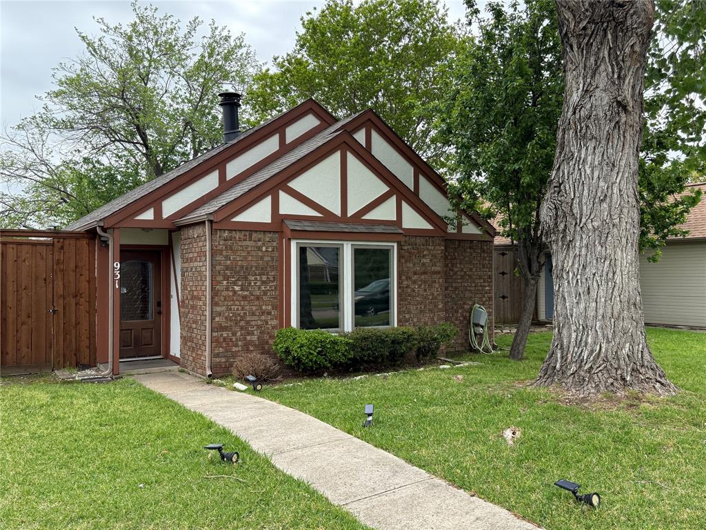 View of front of home featuring a gate, a front yard, fence, and brick siding