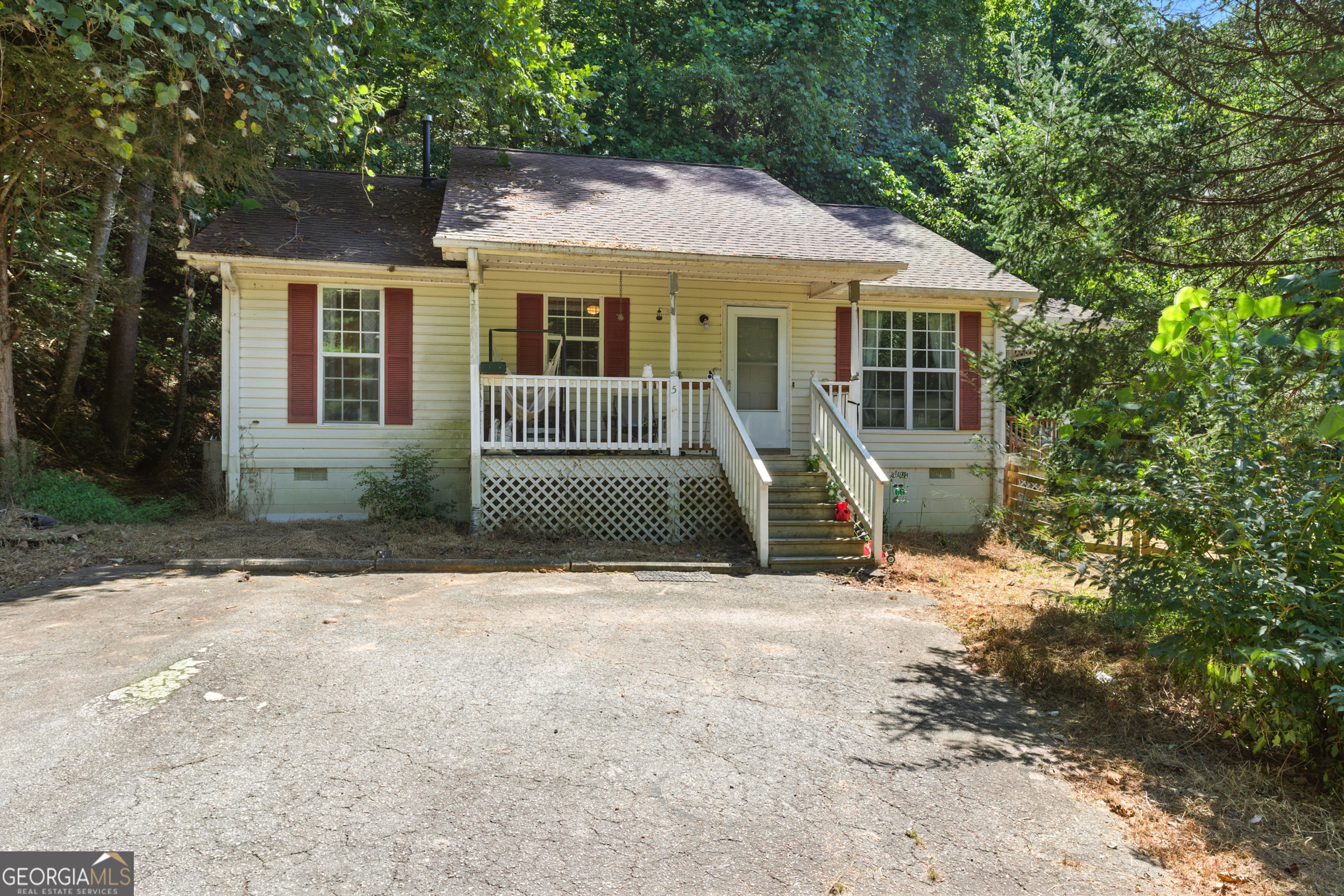 a view of a house with a yard and sitting area