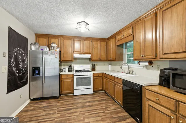 a kitchen with a refrigerator stove and sink