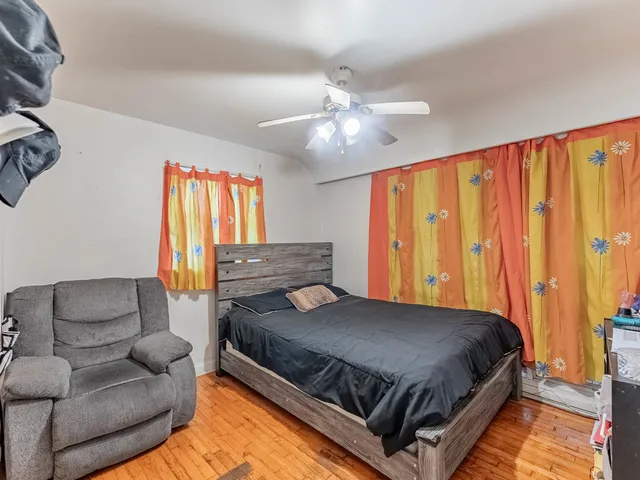 a bedroom with a bed couch and window