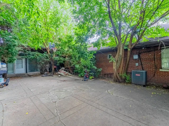 an aerial view of a house with a garden and yard