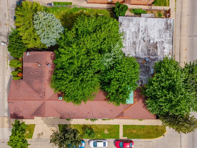 an aerial view of a house with swimming pool and outdoor seating