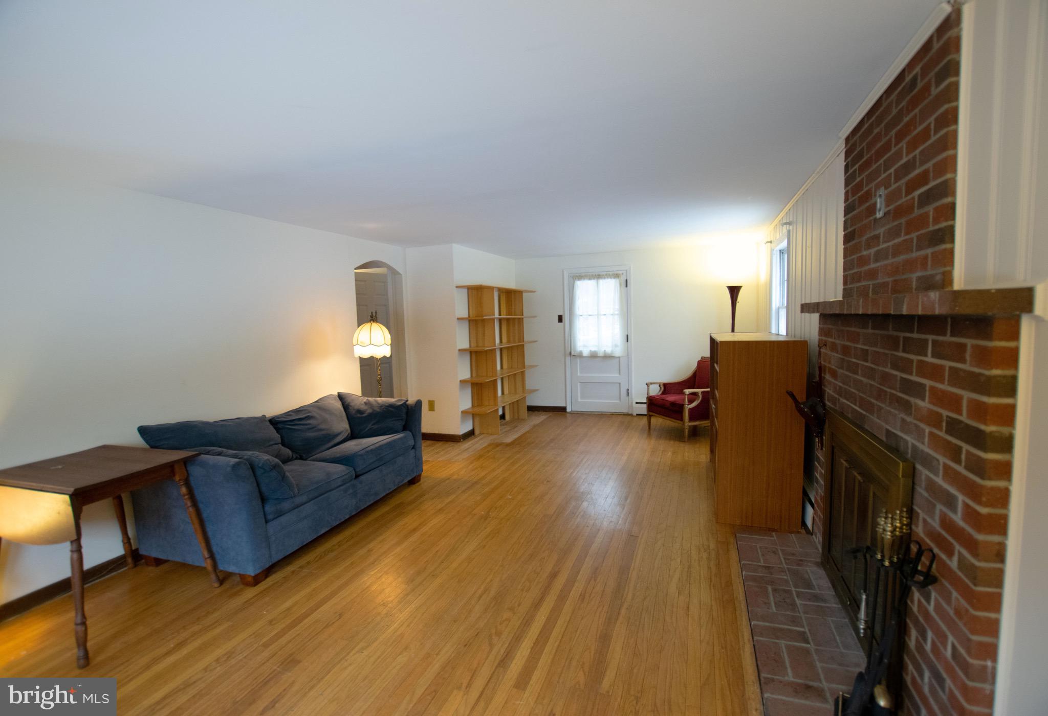 105 Spring Road Malvern, PA 19355 - Photo 2 of 19 Large Living Room with hardwood floor, brick FP