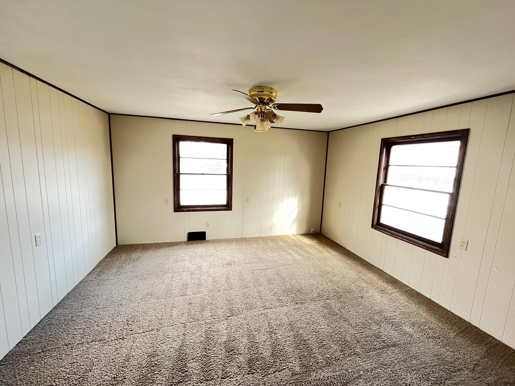 13954 Dorr Road Rockton, IL 61072 - Photo 11 of 21 an empty room with windows and ceiling fan