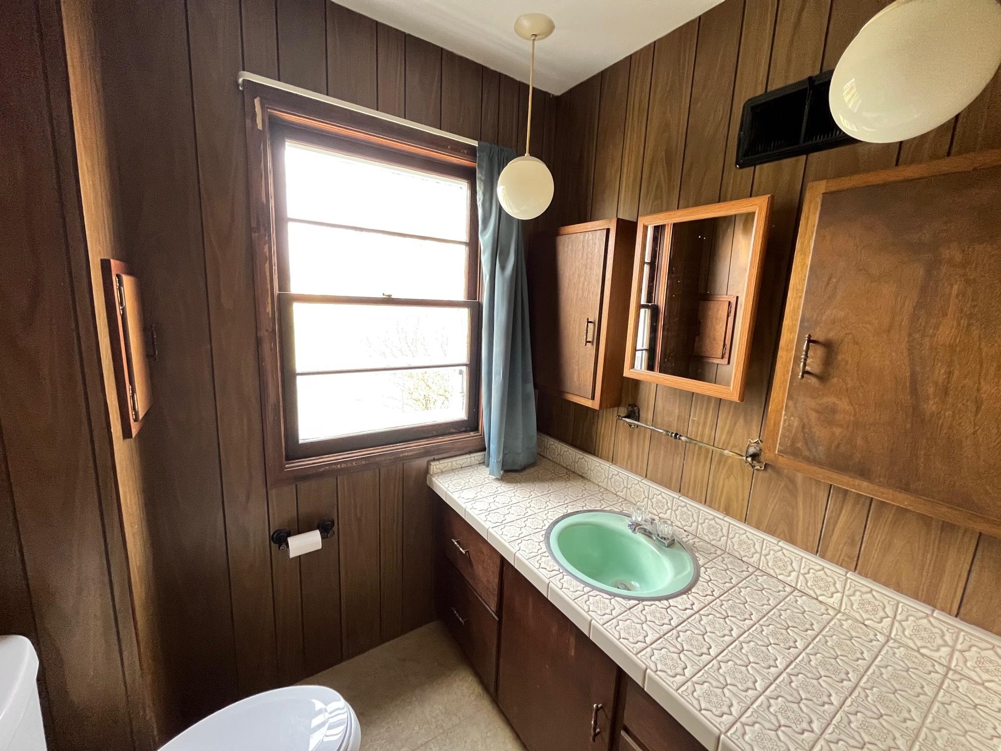 13954 Dorr Road Rockton, IL 61072 - Photo 9 of 21 a bathroom with a granite countertop sink toilet and mirror