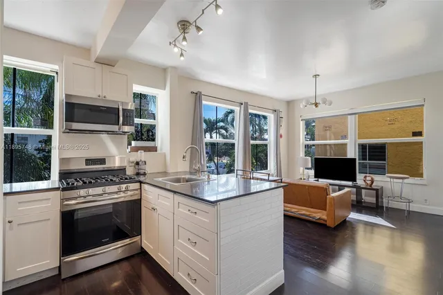 a kitchen with a stove and a wooden floor
