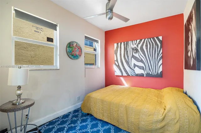 a bedroom with a bed and a painting on the wall