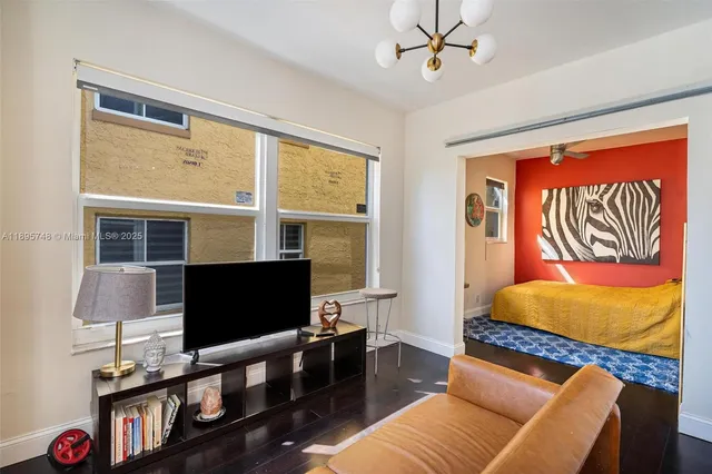 a bedroom with a bed and flat screen tv
