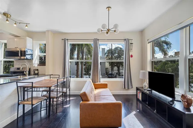 a view of a livingroom with furniture window and wooden floor