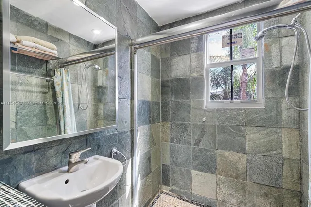 a bathroom with a shower and a sink