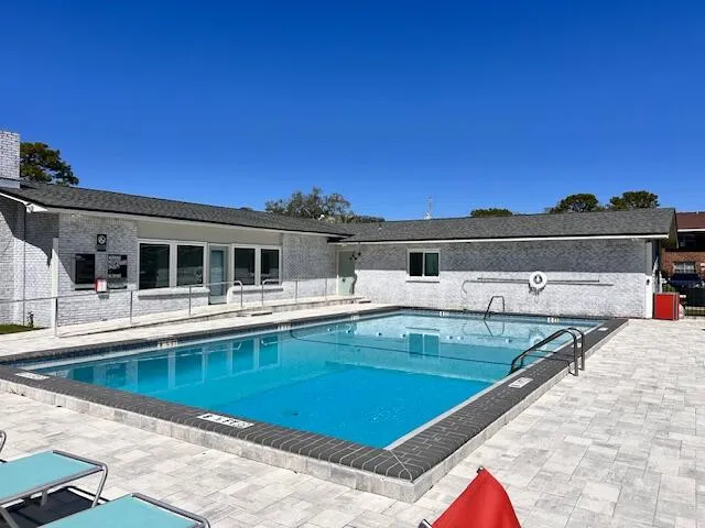 a view of a house with swimming pool and sitting area