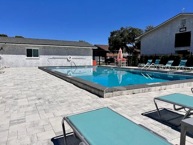 a view of a patio with chairs and plants