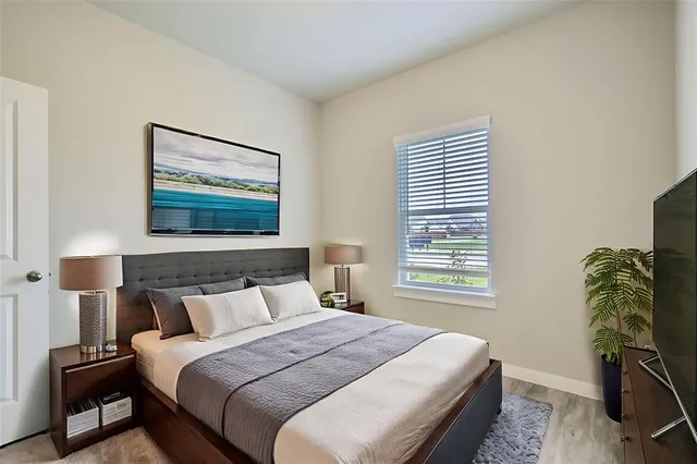 a bedroom with bed and window