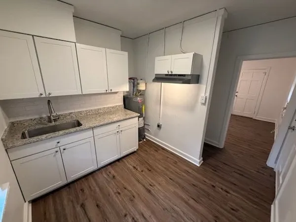 a kitchen with a refrigerator sink and cabinets