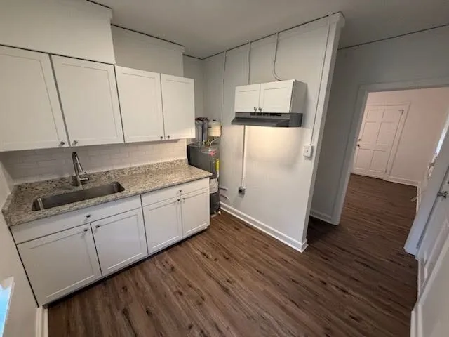 a kitchen with a refrigerator sink and cabinets