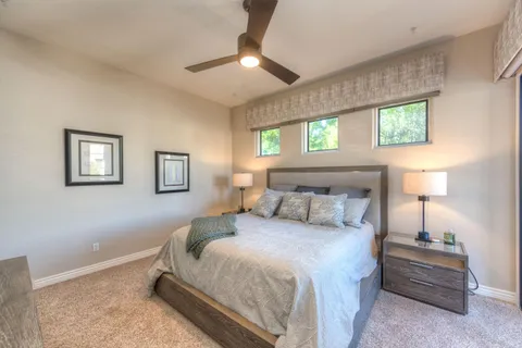 a bedroom with a bed and a chandelier