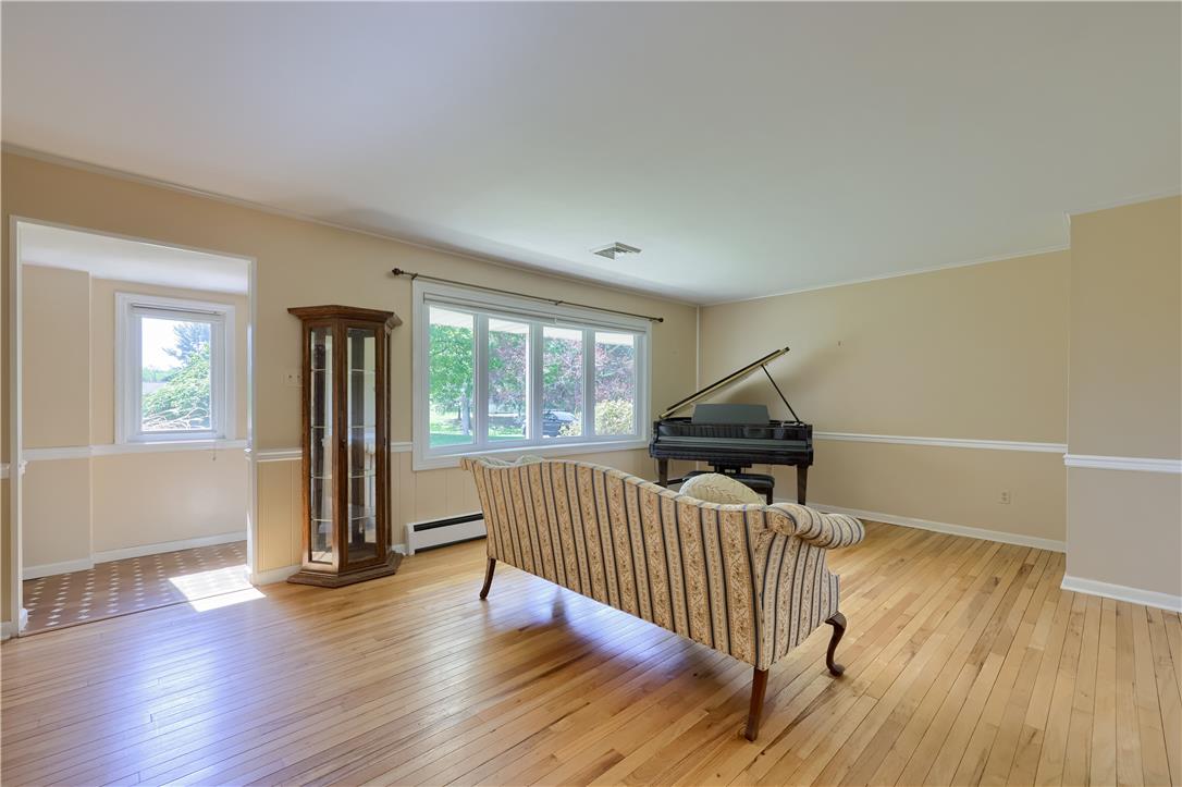 Coldsprings Rd Union Pottstown, PA 19465 - Photo 37 of 71 Well-lit living area featuring rich hardwood flooring and a picturesque window overlooking lush greenery.