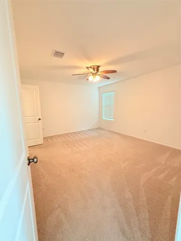 an empty room with a exposed radiator and a window