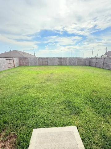 a view of yard with swimming pool and outdoor seating