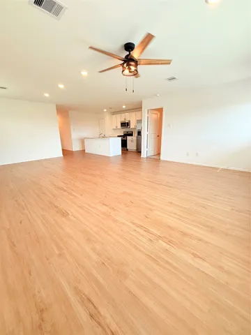 a view of a kitchen with a sink and a ceiling fan