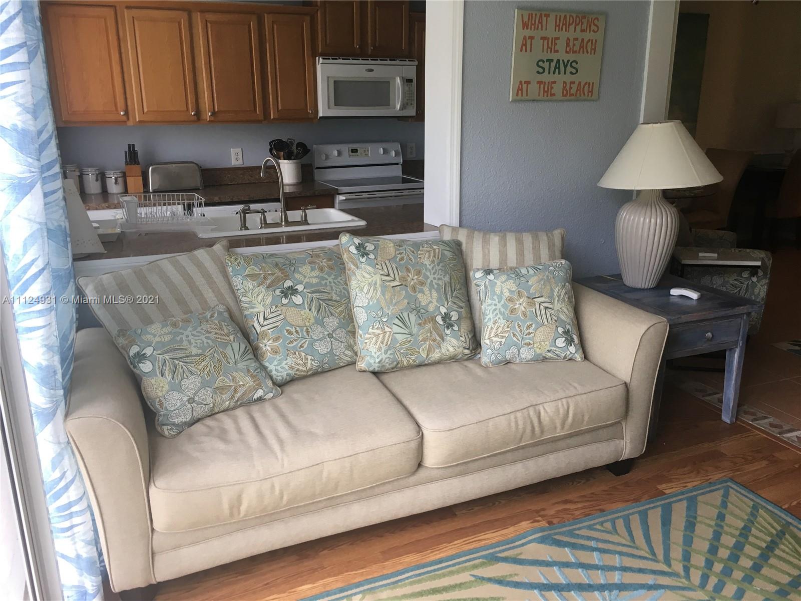 353 Highway 1, Unit D103 Jupiter, FL 33477 - Photo 11 of 11 a living room with a couch and a coffee table