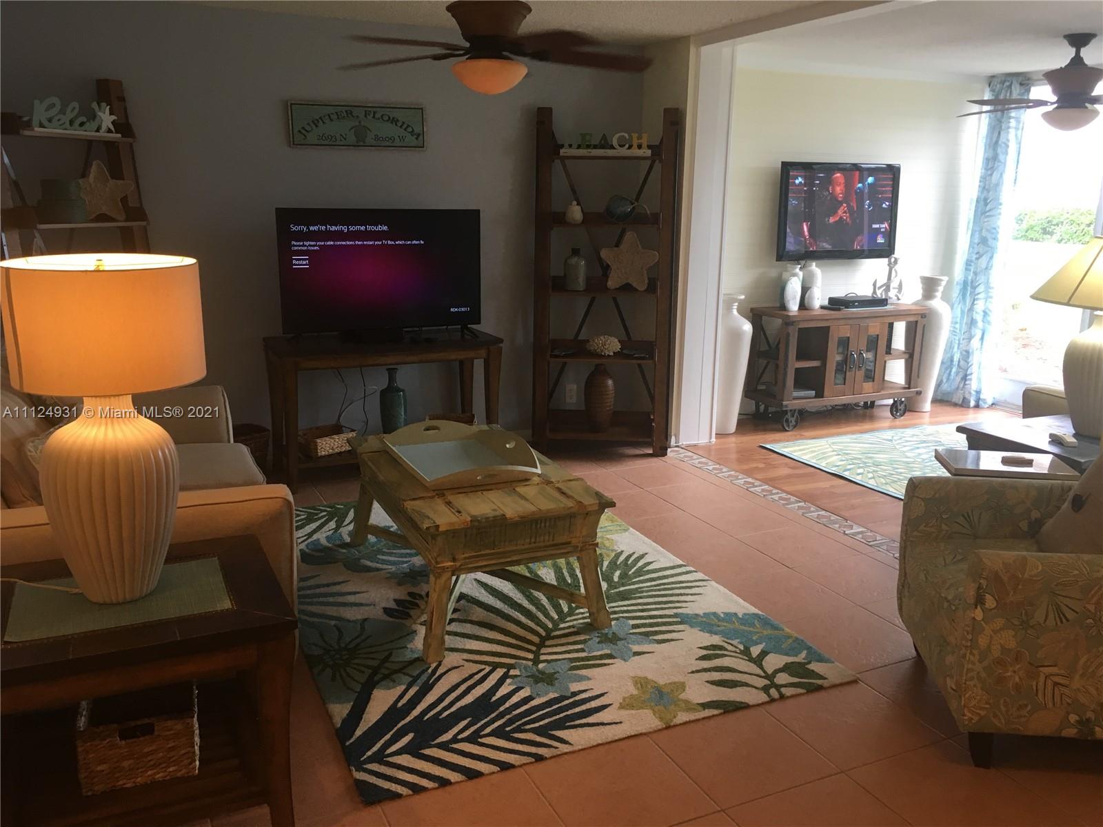 353 Highway 1, Unit D103 Jupiter, FL 33477 - Photo 6 of 11 a living room with furniture and a flat screen tv