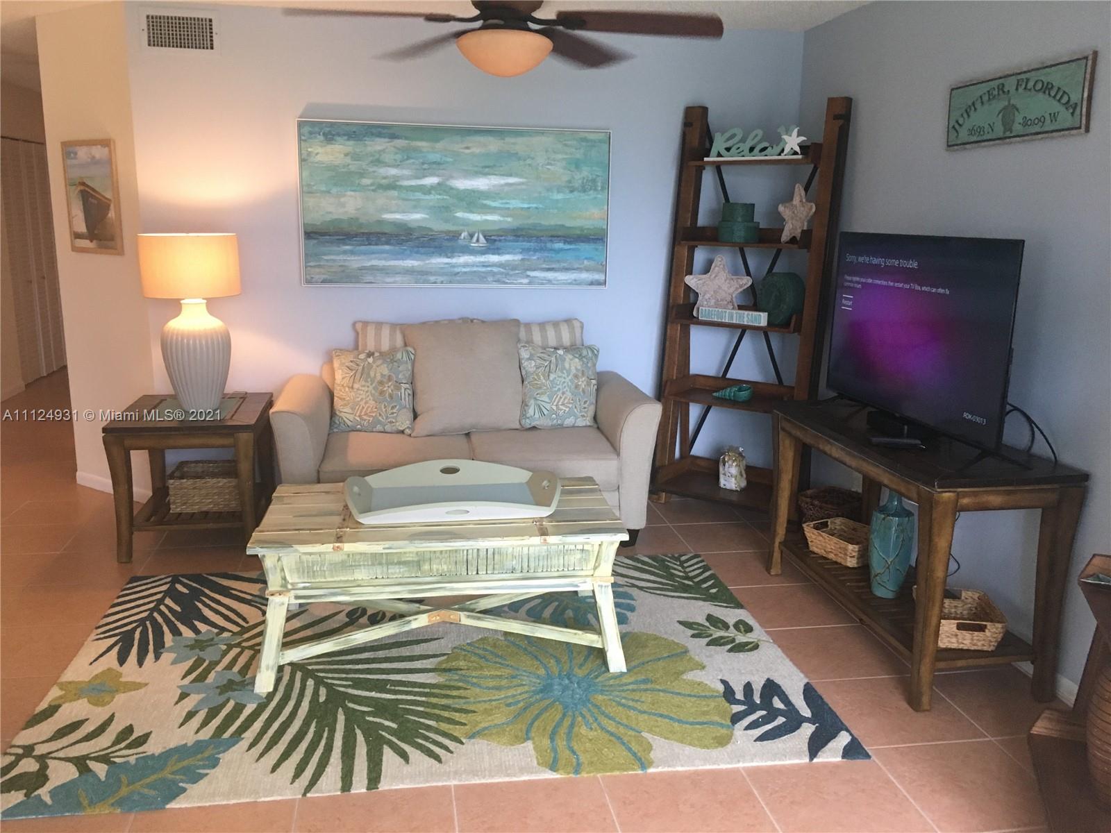 353 Highway 1, Unit D103 Jupiter, FL 33477 - Photo 10 of 11 a living room with furniture and a flat screen tv