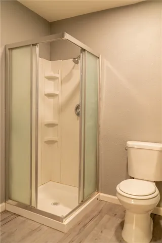 a bathroom with a toilet a sink and a window
