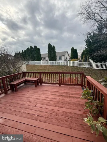 a view of a balcony with wooden floor and iron stairs