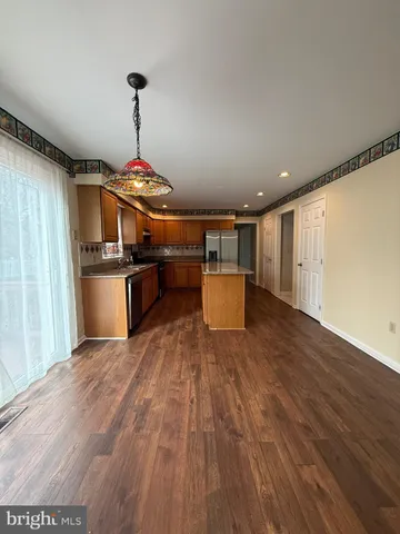 a kitchen with stainless steel appliances granite countertop a sink and a stove top oven