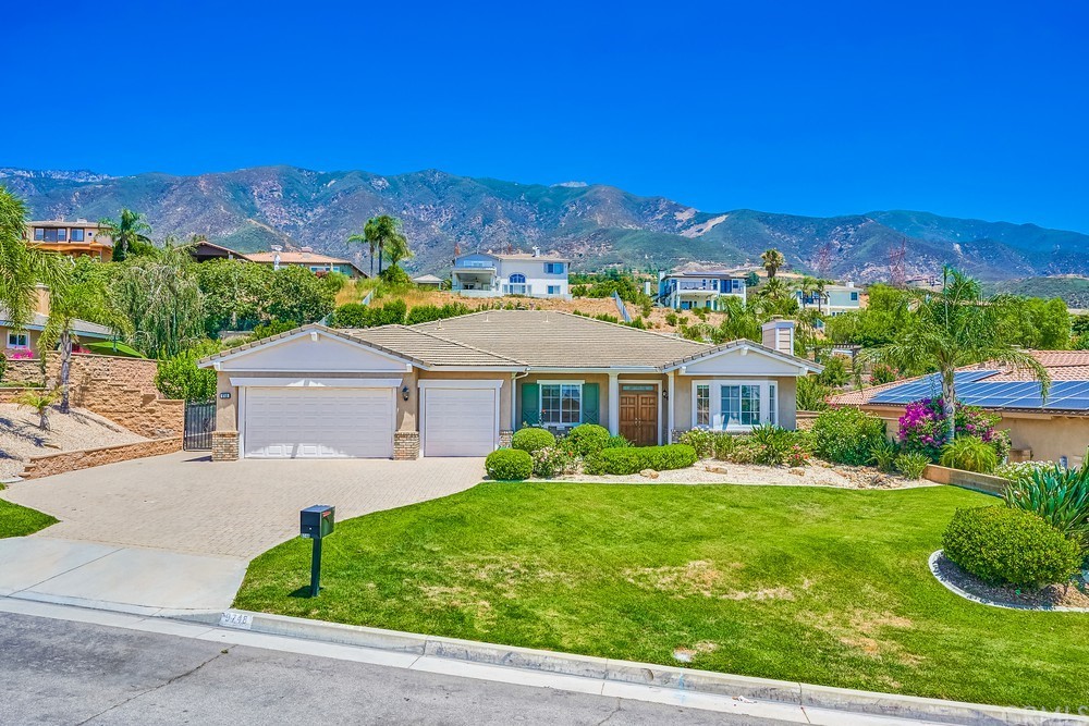 9748 Summerhill Road Rancho Cucamonga, CA 91737 - Photo 1 of 1 a front view of a house with a yard and mountain