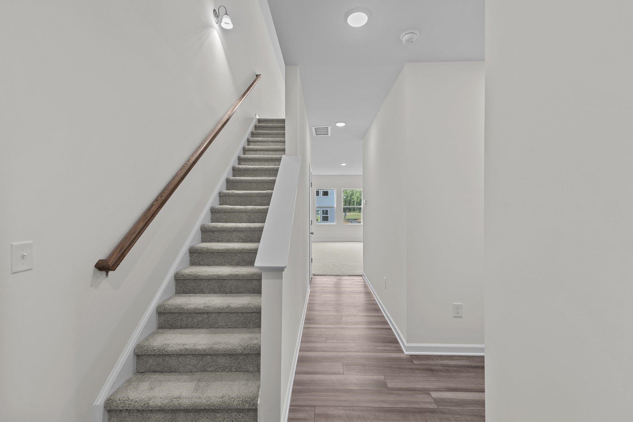 545 Cessna Drive Spring Hope, NC 27882 - Photo 5 of 16 a view of staircase with wooden floor and white walls