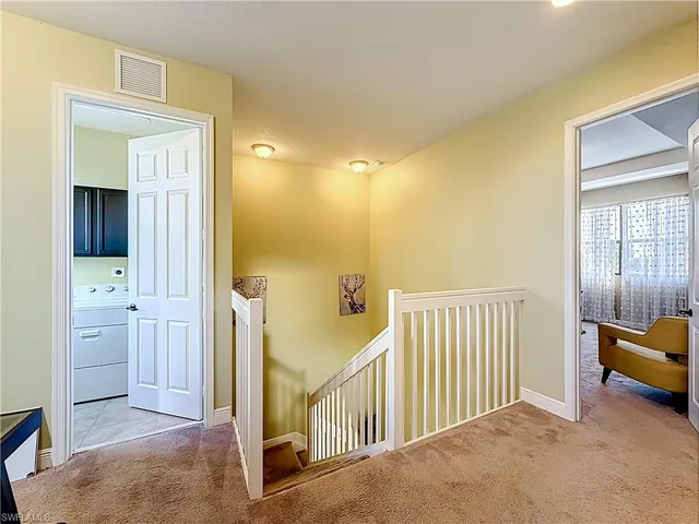 a view of a hallway with closet and a livingroom view