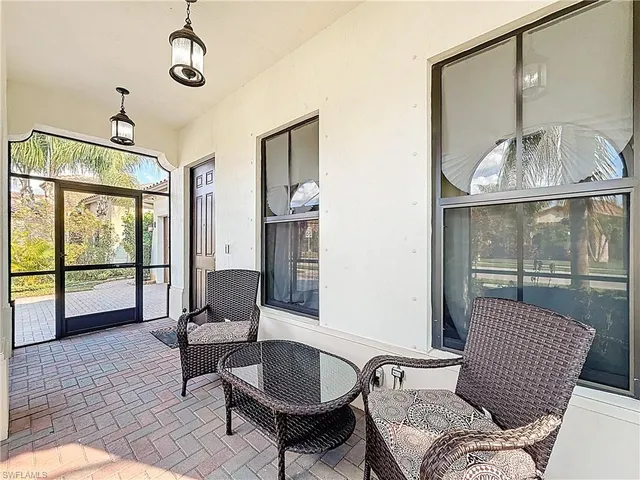 a living room with furniture a fireplace and a floor to ceiling window