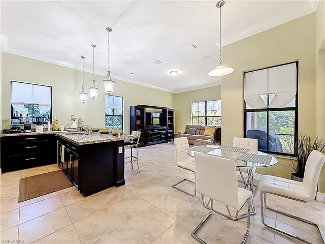 a large kitchen with kitchen island a sink dining table and chairs