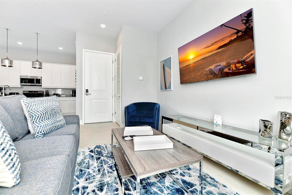 7770 Sandy Ridge Drive, Unit 135 Kissimmee, FL 34747 - Photo 23 of 43 a living room with furniture and a flat screen tv