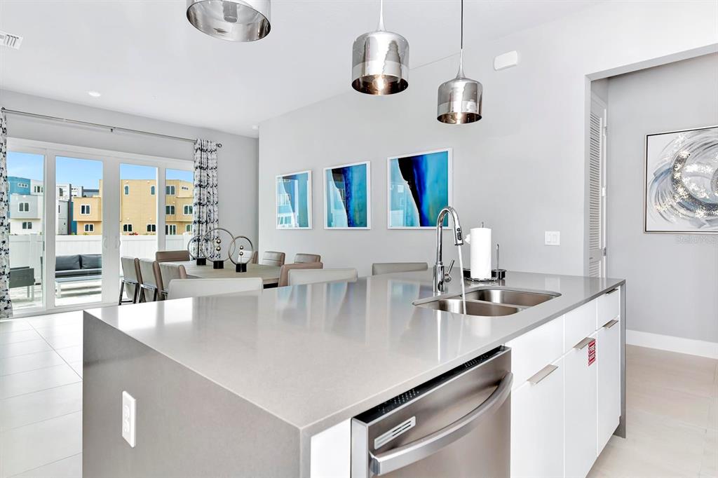 7770 Sandy Ridge Drive, Unit 135 Kissimmee, FL 34747 - Photo 25 of 43 a kitchen with kitchen island stainless steel appliances a sink and living room view