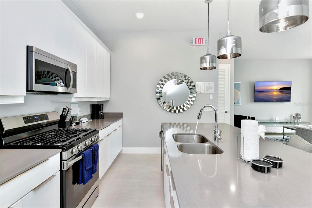 7770 Sandy Ridge Drive, Unit 135 Kissimmee, FL 34747 - Photo 27 of 43 a kitchen with a sink cabinets and appliances