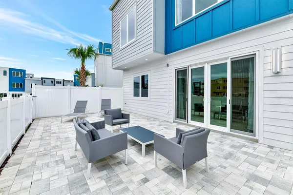 a view of a patio with couches and potted plants