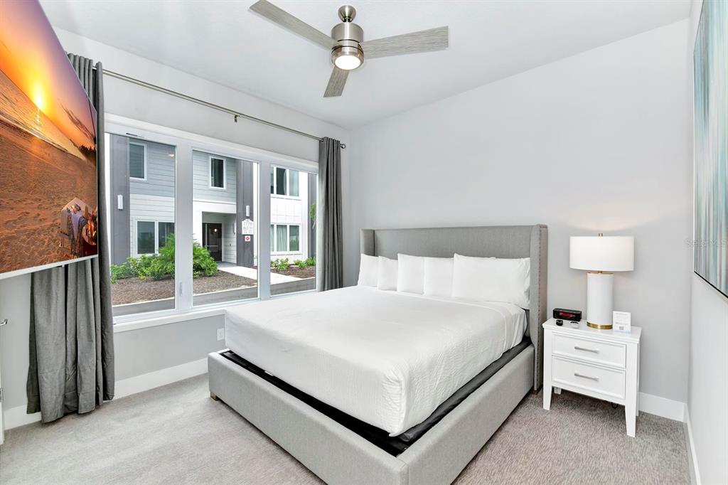 7770 Sandy Ridge Drive, Unit 135 Kissimmee, FL 34747 - Photo 31 of 43 a large white bed sitting in a bedroom next to a large window