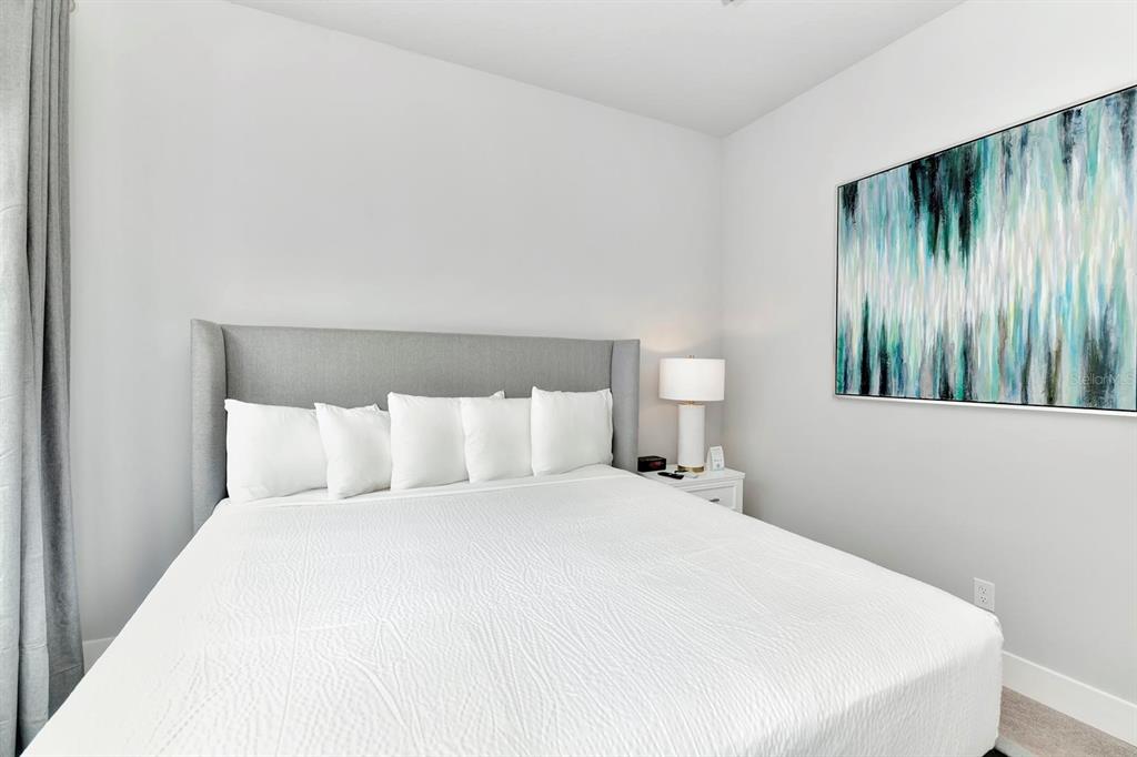 7770 Sandy Ridge Drive, Unit 135 Kissimmee, FL 34747 - Photo 32 of 43 a large bed in a white room
