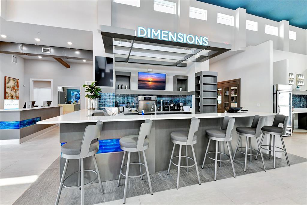 7770 Sandy Ridge Drive, Unit 135 Kissimmee, FL 34747 - Photo 40 of 43 a kitchen with stainless steel appliances kitchen island granite countertop a table chairs sink and cabinets