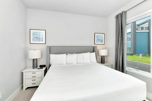 a bedroom with a bed and a lamp