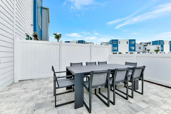 a view of a dinning table and chairs in the patio