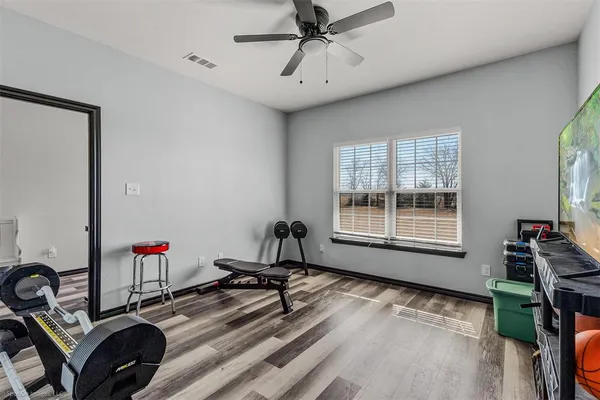 a room with gym equipment and a window