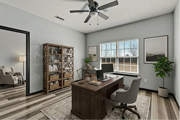 a living room with furniture and a potted plant