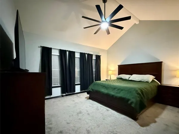 a bedroom with a bed closet and a large mirror