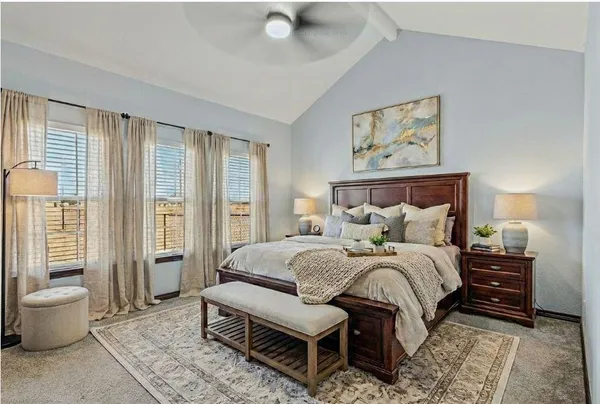 a bedroom with a large bed and a large window